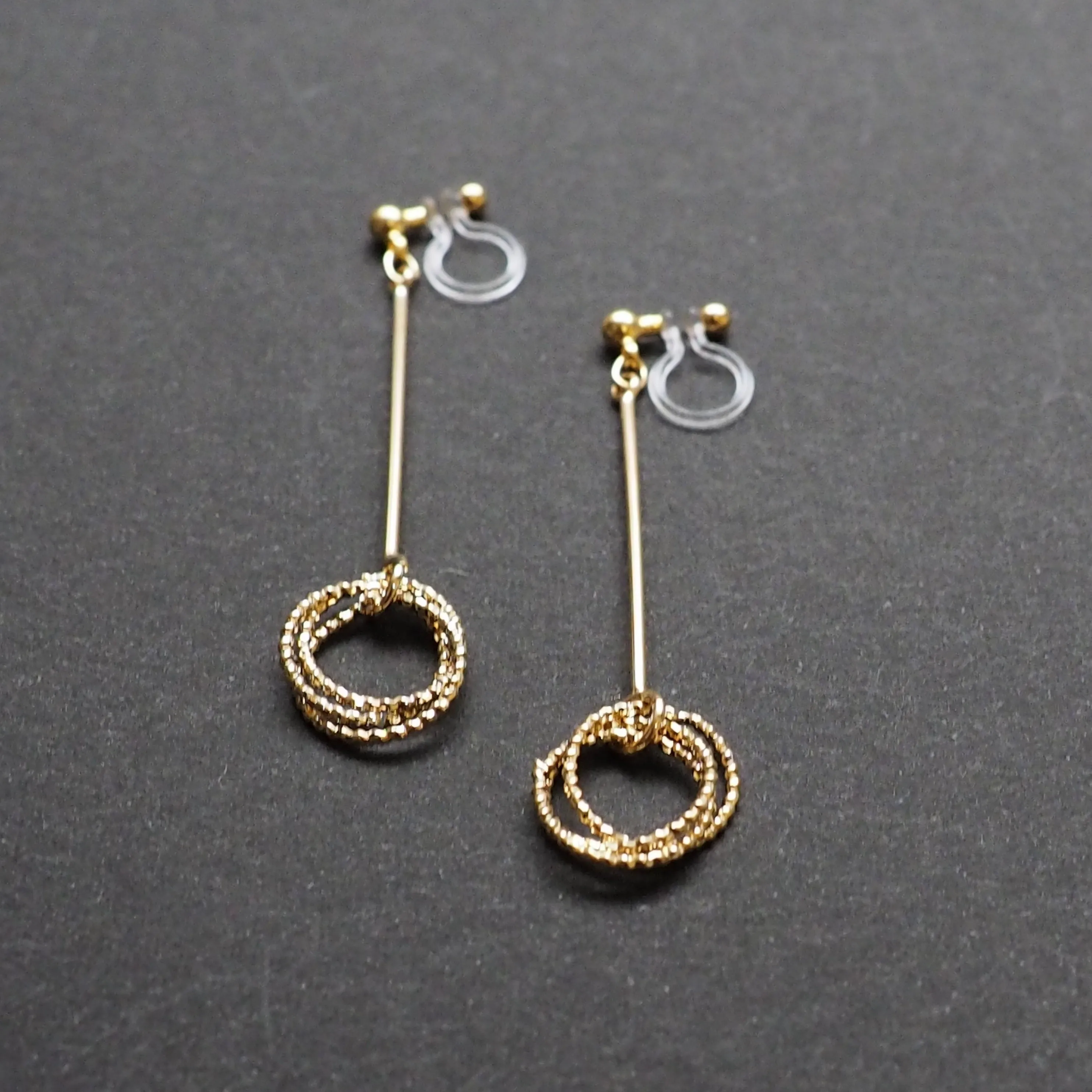 Textured triple hoop clip on earrings ( Gold tone )