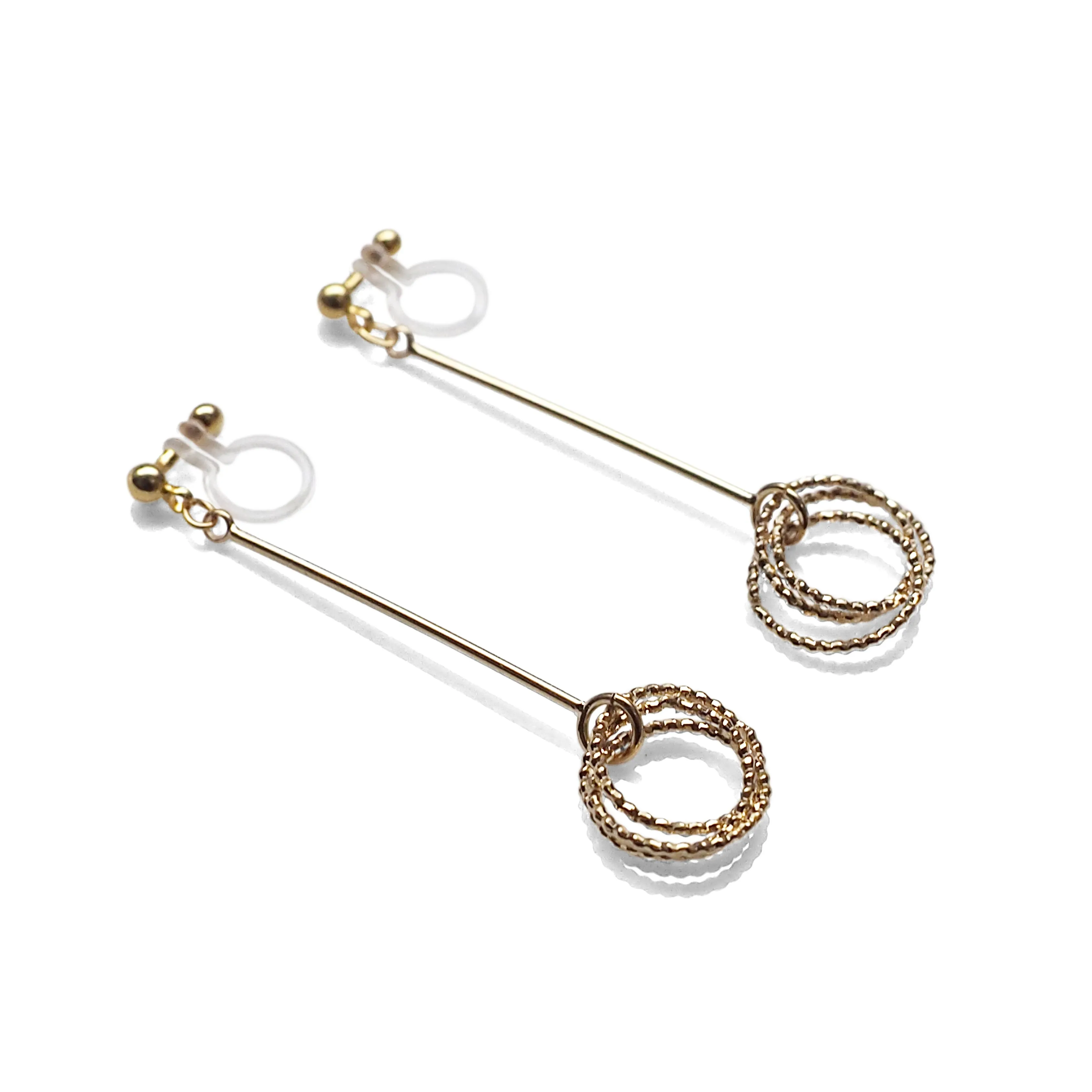 Textured triple hoop clip on earrings ( Gold tone )
